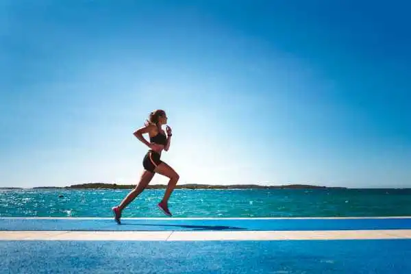 Woman running showing strong leg muscle Frimley